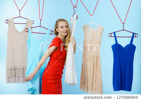 Woman choosing clothes in shop Woman choosing clothes in shop 125906669