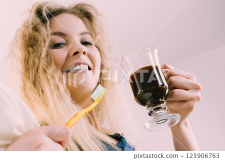 Funny woman being late drinking coffee Funny woman being late drinking coffee 125906763