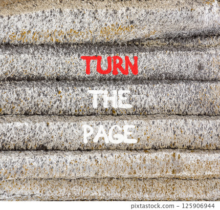 Turn the page symbol. Concept words Turn the page on beautiful grey stone wall. Beautiful grey mountain stone wall background. Business motivational lifestyle turn the page concept. Copy space. 125906944