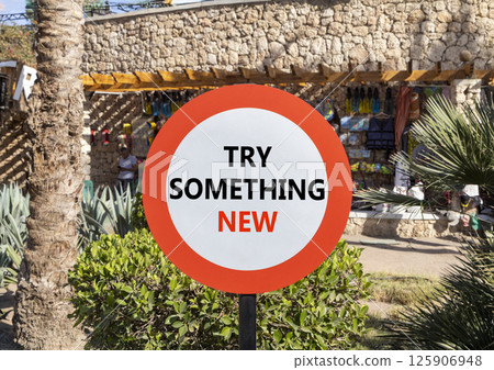 Try something new symbol. Concept words Try something new on beautiful big white road sign. Beautiful palm tree hotel background. Business motivational lifestyle try something new concept. Copy space. Try something new symbol. Concept words Try something new on beautiful big white road sign. Beautiful palm tree hotel background. Business motivational lifestyle try something new concept. Copy space. 125906948
