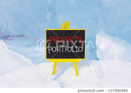 Property portfolio symbol. Concept words Property portfolio on beautiful yellow blackboard. Beautiful blue ice background. Business Property portfolio concept. Copy space. 125906966