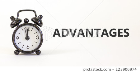 Advantages symbol. Concept word Advantages on beautiful white paper. Beautiful white paper background. Black alarm clock. Business advantages concept. Copy space. 125906974