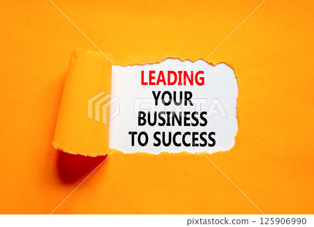 Leading your business to success symbol. Concept words Leading your business to success on beautiful white paper. Beautiful orange paper background. Leading your business to success concept Copy space Leading your business to success symbol. Concept words Leading your business to success on beautiful white paper. Beautiful orange paper background. Leading your business to success concept Copy space 125906990