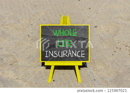 Whole life insurance symbol. Concept words Whole life insurance on beautiful black yellow blackboard. Beautiful sand beach background. Business whole life insurance concept. Copy space. 125907021