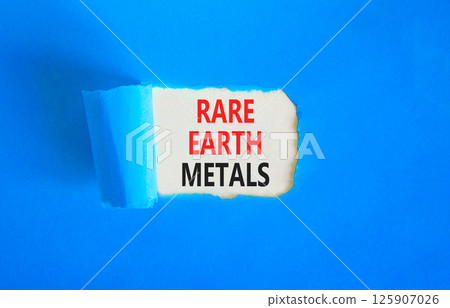 Rare earth metals symbol. Concept words Rare earth metals on beautiful white paper. Beautiful blue paper background. Business and rare earth metals concept. Copy space. Rare earth metals symbol. Concept words Rare earth metals on beautiful white paper. Beautiful blue paper background. Business and rare earth metals concept. Copy space. 125907026