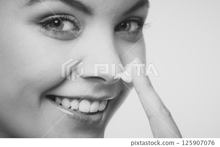 woman applying cream on her skin face. woman applying cream on her skin face. 125907076