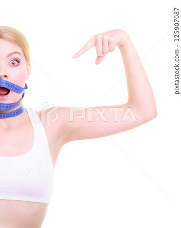 Obsessed girl with violet measure tapes around her head 125907087