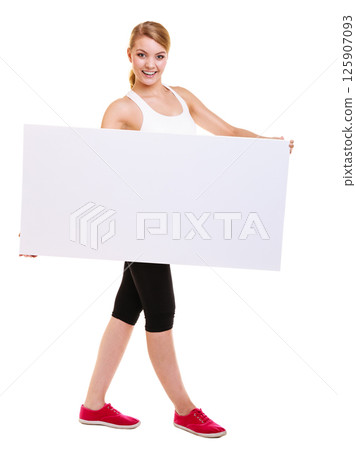 Fitness woman presenting blank empty ad banner 125907093