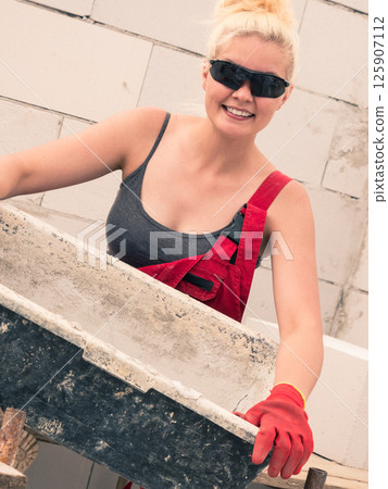 Female builder working build new house Female builder working build new house 125907112