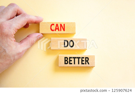Can do better symbol. Concept words Can do better on beautiful wooden block. Businessman's hand. Beautiful white background. Business and can do better concept. Copy space. 125907624