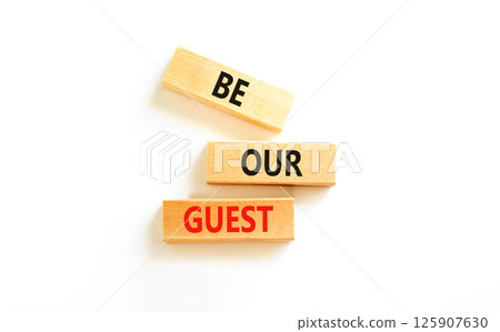 Be our guest symbol. Concept words Be our guest on beautiful wooden block. Beautiful white table white background. Business and be our guest concept. Copy space. 125907630