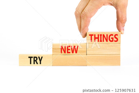 Try new things symbol. Concept words Try new things on beautiful wooden block. Businessman's hand. Beautiful white background. Business motivational lifestyle try new things concept. Copy space. 125907631