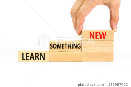 Learn something new symbol. Concept words Learn something new on beautiful block. Businessman's hand. Beautiful white background Business motivational lifestyle learn something new concept Copy space 125907632