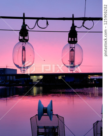 Ship lamp at sunrise 125908282