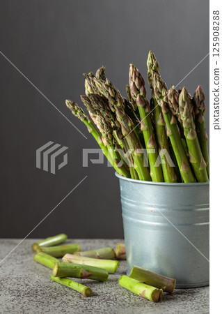 Fresh asparagus on a gray background. Fresh asparagus on a gray background. 125908288