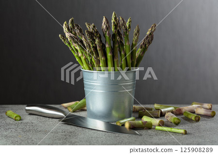Fresh asparagus on a gray background. Fresh asparagus on a gray background. 125908289