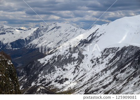 Snowcapped peaks of Caucasus mountains along the Georgian Military Road, major route from Georgia to Russia 125909081