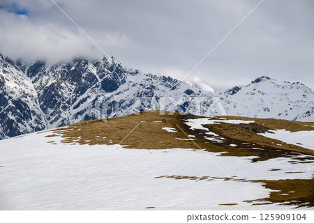 Snowcapped peaks of Caucasus mountains along the Georgian Military Road, major route from Georgia to Russia 125909104