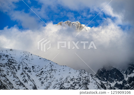 Snowcapped peaks of Caucasus mountains along the Georgian Military Road, major route from Georgia to Russia Snowcapped peaks of Caucasus mountains along the Georgian Military Road, major route from Georgia to Russia 125909106