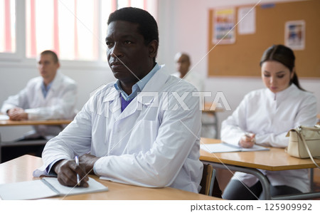 Young man studying with colleagues medicals 125909992