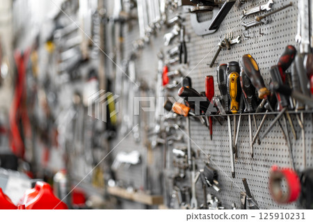 Various hand tools organized on pegboard in Various hand tools organized on pegboard in 125910231