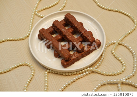 Stylish Dessert Display with Chocolate Bars and Pearls Stylish Dessert Display with Chocolate Bars and Pearls 125910875