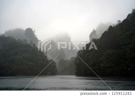 Misty Baofeng Lake with Calm Water and Rock Cliffs in Zhangjiajie, China 125911281