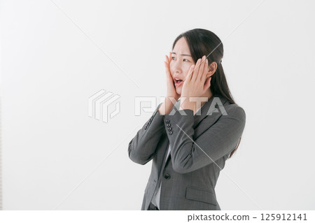 A woman in a suit with a worried expression 125912141