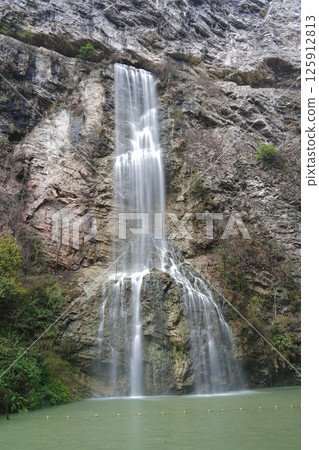 Majestic Waterfall Cascading Down a Rugged Cliff Face 125912813