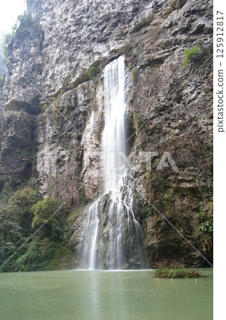 Majestic Waterfall Cascading Down a Rugged Cliff Face Majestic Waterfall Cascading Down a Rugged Cliff Face 125912817