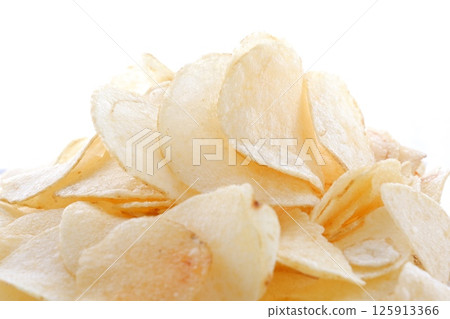 A pile of potato chips on a white plate A pile of potato chips on a white plate 125913366