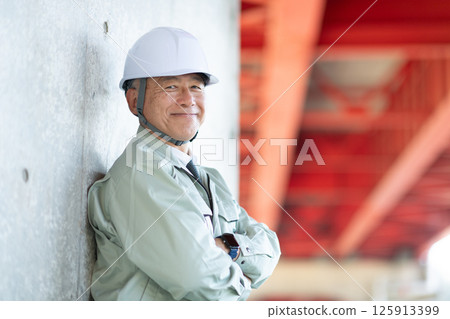 Veteran site supervisor with his arms folded 125913399