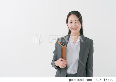 Businesswoman holding a file Businesswoman holding a file 125913749