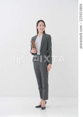Businesswoman holding a file Businesswoman holding a file 125913804