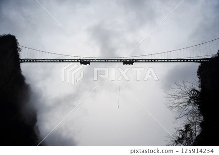 Bungee Jump from a Bridge Under Cloudy Sky Bungee Jump from a Bridge Under Cloudy Sky 125914234