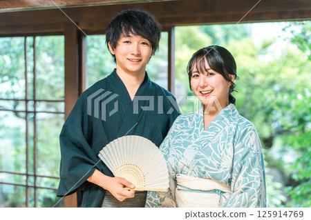 Asian couple in yukata sitting on the veranda of a Japanese house 125914769