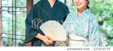 Asian couple in yukata sitting on the veranda of a Japanese house 125914770