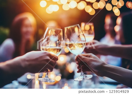 Cheerful Friends Toasting with Glasses at Sunset Cheerful Friends Toasting with Glasses at Sunset 125914929