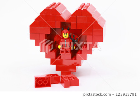 devil dressing child hide inside the heart shaped brick devil dressing child hide inside the heart shaped brick 125915791
