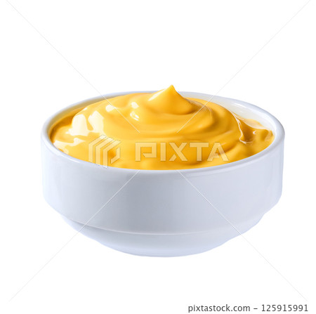 Bowl with tasty cheddar cheese sauce isolated on white background. Bowl with tasty cheddar cheese sauce isolated on white background. 125915991