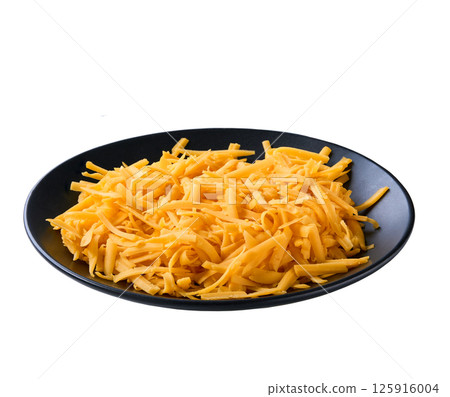 shredded cheddar cheese in a black plate isolated on a white background. 125916004