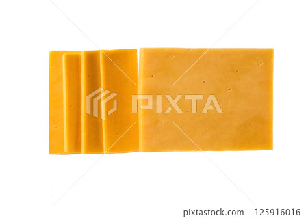pieces of cheddar cheese isolated on a white background, top view. 125916016