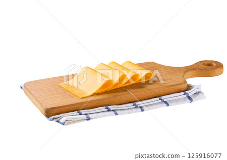 cutting board with pieces of cheddar cheese isolated on a white background. 125916077
