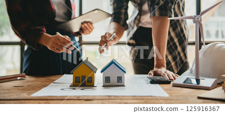Engineer teams meeting working together wear worker helmets hardhat on construction site in modern city. Engineer teams meeting working together wear worker helmets hardhat on construction site in modern city. 125916367