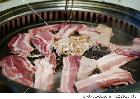 Close-Up of Delicious Korean Barbecue with Samgyeopsal (Pork Belly) Close-Up of Delicious Korean Barbecue with Samgyeopsal (Pork Belly) 125916435