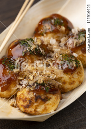 Takoyaki served on a wooden boat plate 125916603