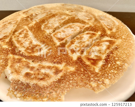 Stock Photo: Dumplings with wings served on a white plate 125917213