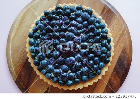 Homemade blueberry tart topped with plenty of delicious freshly picked blueberries. 125917475