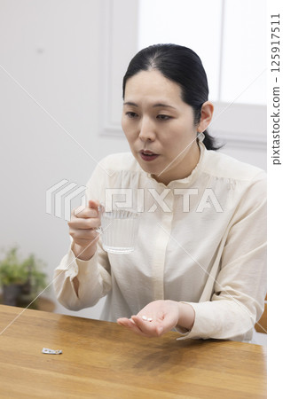 Woman taking medicine 125917511