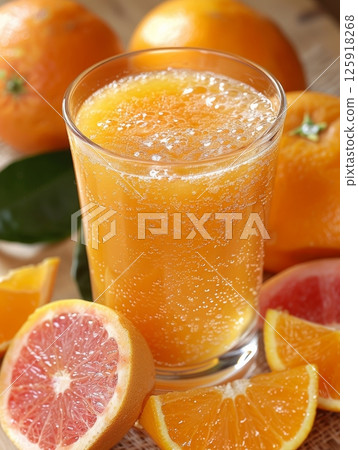 A glass of fresh orange juice with dripping condensation A glass of fresh orange juice with dripping condensation 125918268